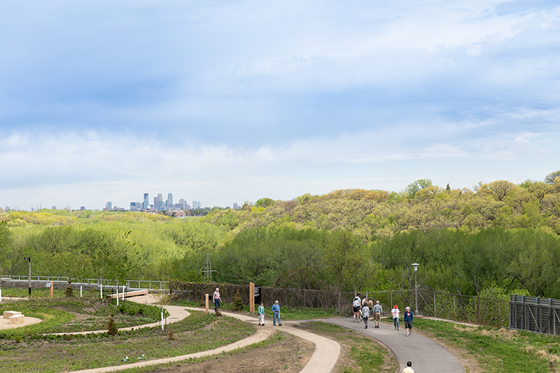 Visitors walking along the Ecolab River Walk